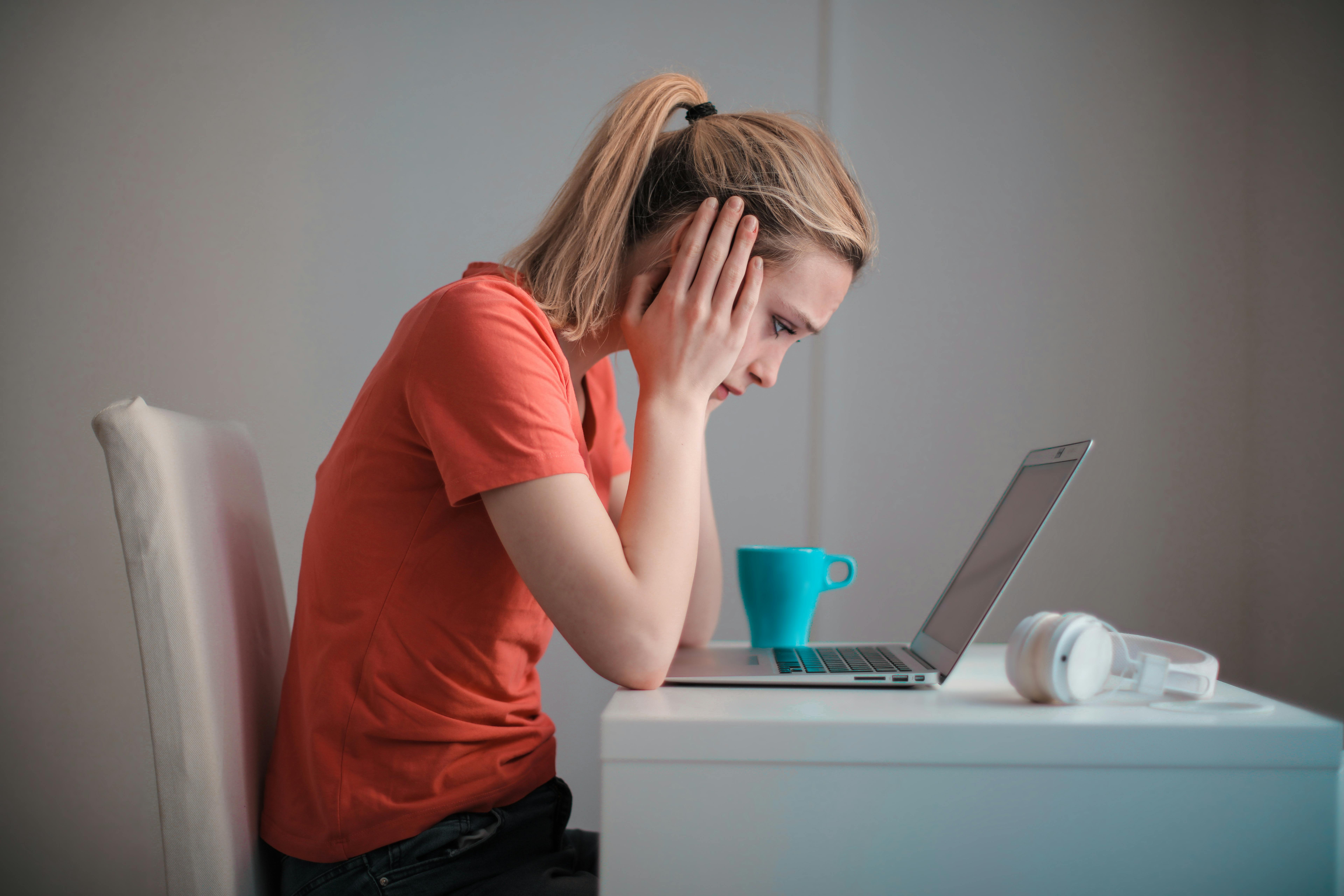 Woman with hand on face shopping for answering service