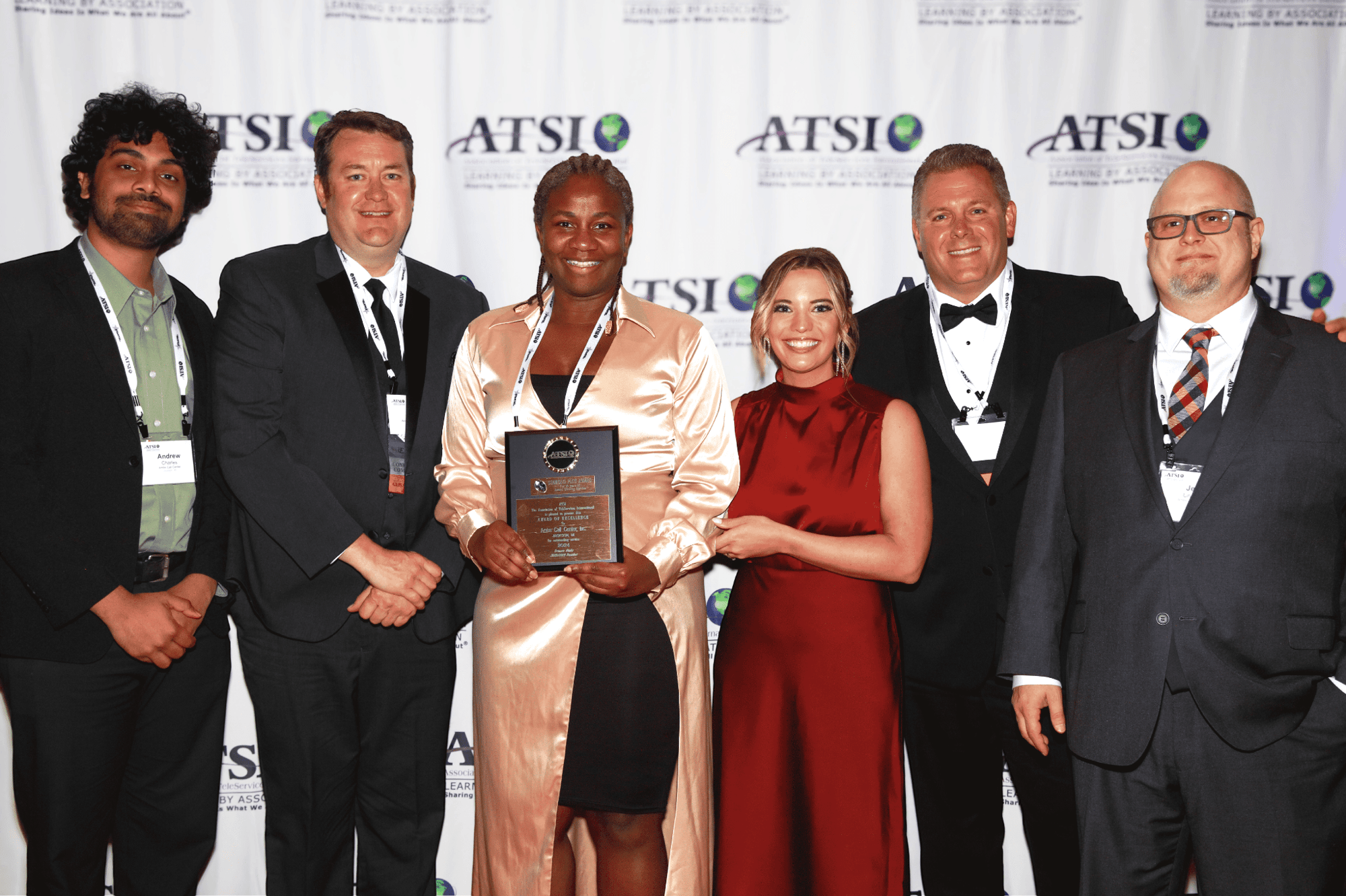 Ambs Call Center accepting ATSI 2024 award of excellence 