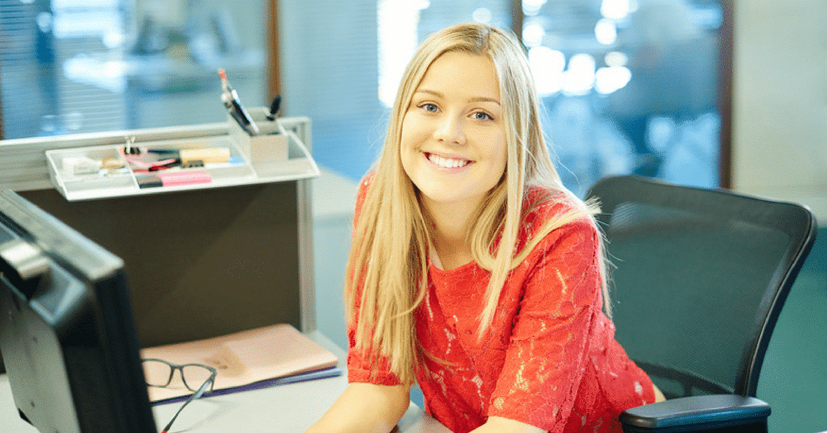 woman call center agent smiling while looking at the camera