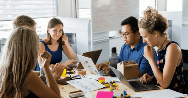 people gathered around a table discussing best virtual receptionist options